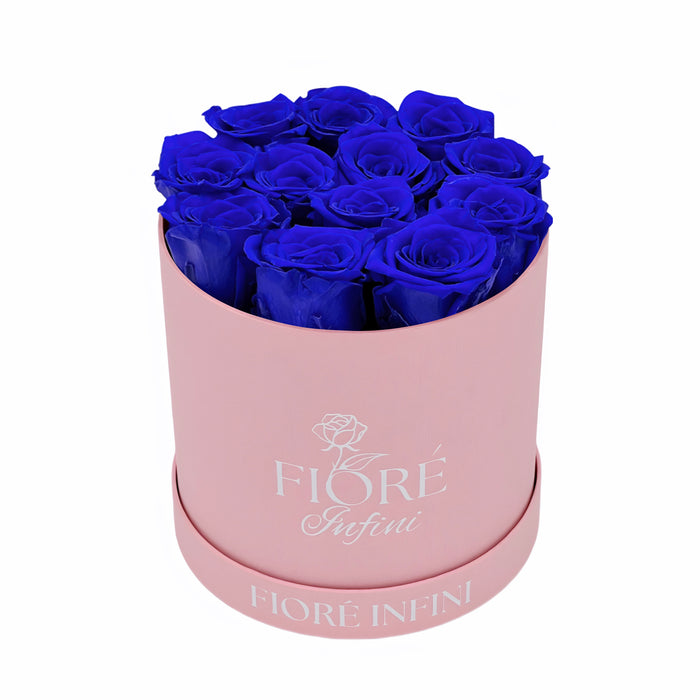 12 preserved blue roses in a pink box
