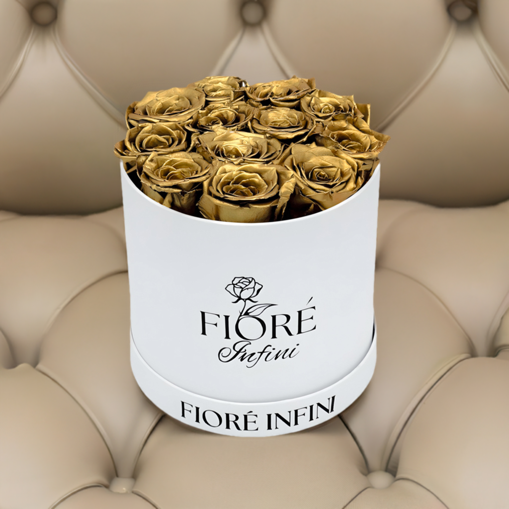 gold roses in a white box