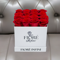red roses in square white box on a luxury sofa
