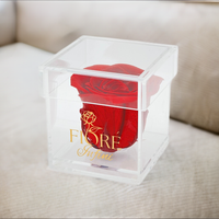 single red rose in an acrylic square box