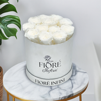 white roses in a silver box, on a marble table