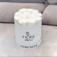 white roses in a round white box