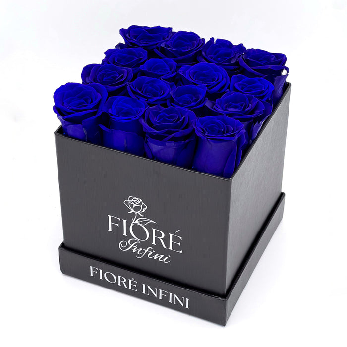 16 royal blue forever roses in a square black box