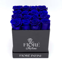 16 royal blue forever roses in a square black box by Fiore Infini