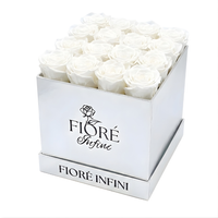 white preserved roses in a silver square box