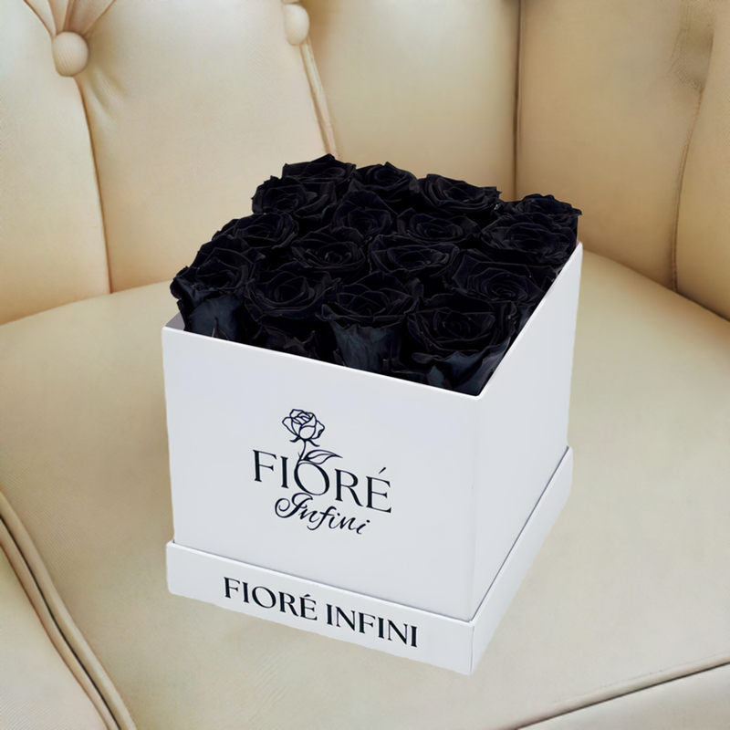 black roses in a white box