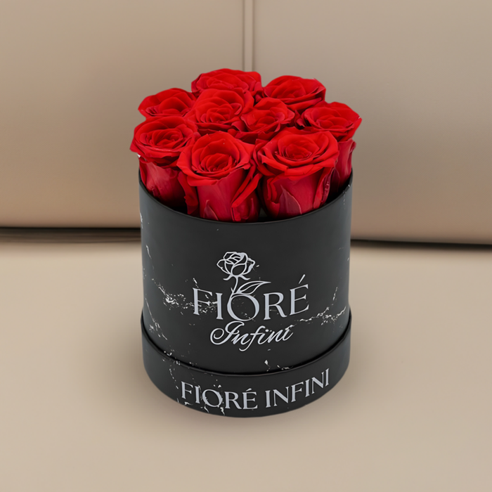 red roses in a black marble box on a beige sofa