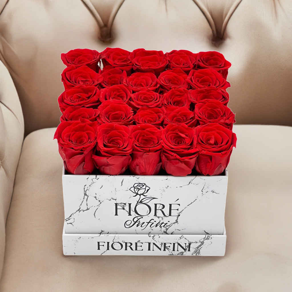 preserved red roses in marble box on a luxury sofa