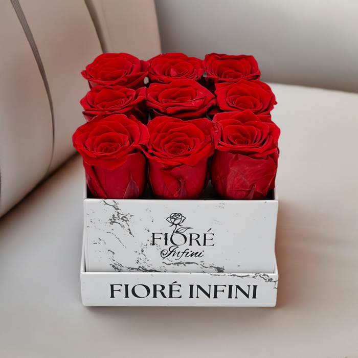Red Preserved Roses In A Small Square Marble Box on a luxury sofa