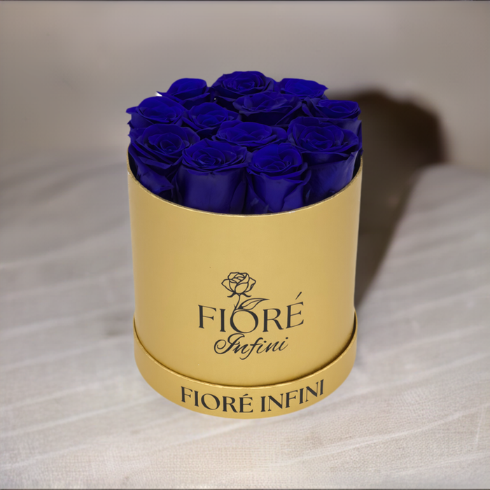 royal blue roses in a gold round box