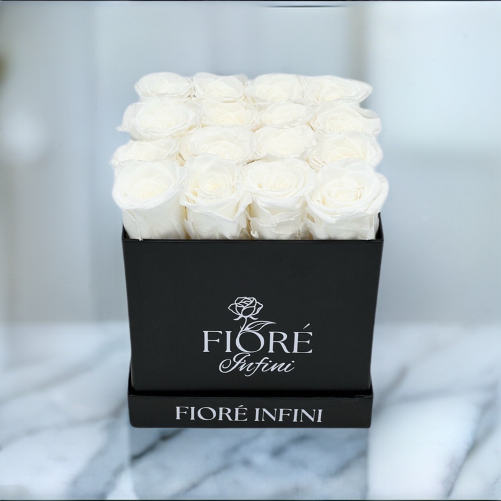 white forever roses in a black box