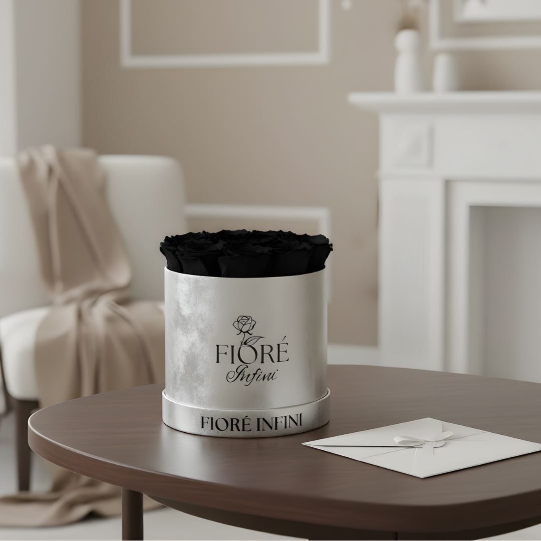 black preserved roses in a silver box displayed on a table