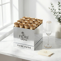 gold roses in silver box placed on a marble table