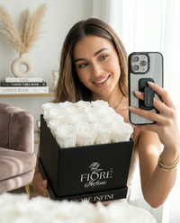 lady taking a selfie with her white preserved rose box