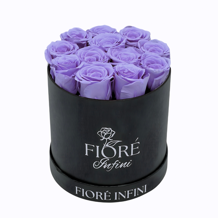 preserved purple roses in a round black box