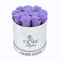 purple preserved roses in a silver round box