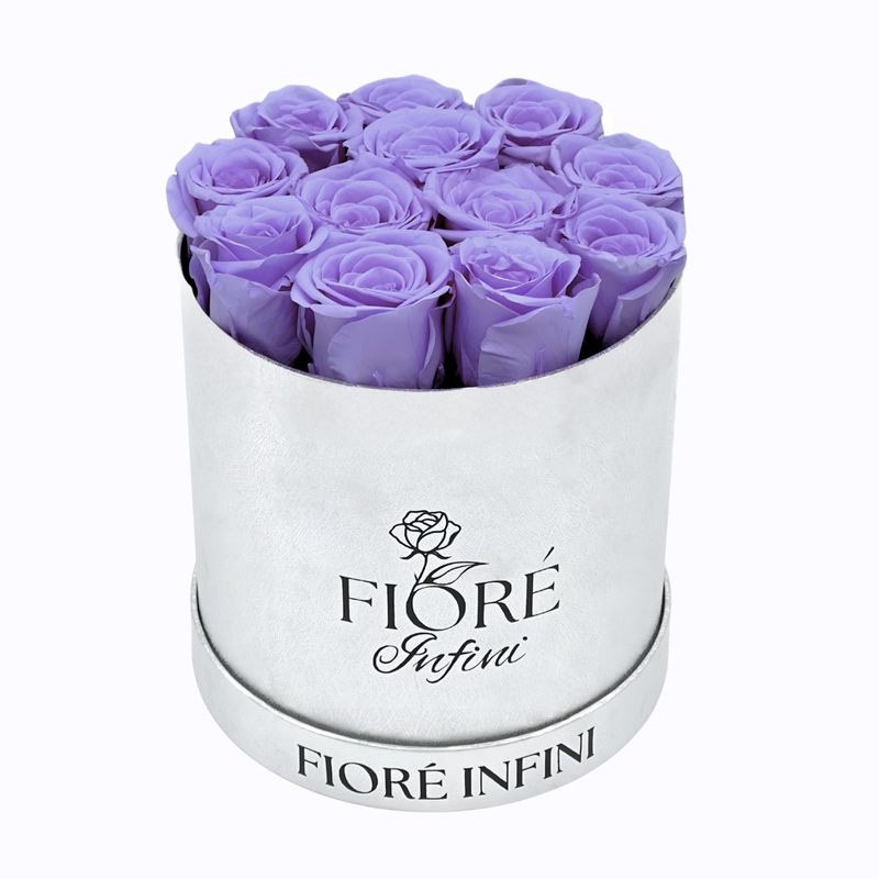purple preserved roses in a silver round box