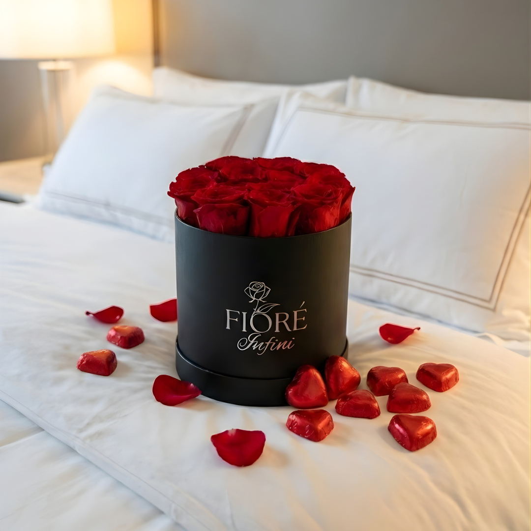 red preserved roses in a box and 
chocolates