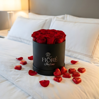 red preserved roses in a box and 
chocolates